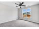 Large bedroom with plush carpeting, a ceiling fan, and views of the neighborhood at 186 Gumtop Dr, Zebulon, NC 27597