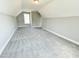 This bedroom features plush gray carpet, ample natural light from the single window, and a closet at 186 Gumtop Dr, Zebulon, NC 27597