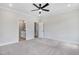 Spacious bedroom with gray carpet and access to a modern bathroom and walk-in closet at 186 Gumtop Dr, Zebulon, NC 27597