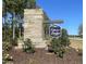 Stone community entrance sign surrounded by mulch and bushes under a clear blue sky at 186 Gumtop Dr, Zebulon, NC 27597