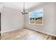 Dining room featuring stylish light fixture, a large window, and neutral walls with light-colored floors at 186 Gumtop Dr, Zebulon, NC 27597