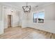 Modern dining room featuring hardwood floors, wainscoting, modern light fixture and large window at 186 Gumtop Dr, Zebulon, NC 27597