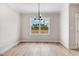 Dining room with modern chandelier, bright walls, and a scenic view through a large window at 186 Gumtop Dr, Zebulon, NC 27597