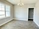 Bright dining room with gray walls, wood floors, and a modern light fixture at 186 Gumtop Dr, Zebulon, NC 27597
