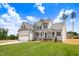 Two-story home with gray siding, black shutters, green lawn, and a walkway to a covered front porch at 186 Gumtop Dr, Zebulon, NC 27597