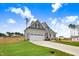 Two-story home featuring gray siding, black shutters, and a well-manicured lawn, framed by mature trees at 186 Gumtop Dr, Zebulon, NC 27597