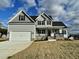 Charming two-story home with a two-car garage, covered porch, and gray siding at 186 Gumtop Dr, Zebulon, NC 27597