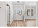 Bright foyer featuring hardwood floors, a white front door, and natural light streaming in through a window at 186 Gumtop Dr, Zebulon, NC 27597