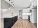 Stylish kitchen with a central island, pendant lighting, and white cabinets, near staircase at 186 Gumtop Dr, Zebulon, NC 27597