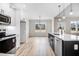 Modern kitchen with island with black cabinets, stainless appliances, and eat-in area near the window at 186 Gumtop Dr, Zebulon, NC 27597