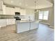 Modern kitchen featuring granite countertops, white cabinets, and stainless steel appliances at 186 Gumtop Dr, Zebulon, NC 27597