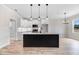 Open-concept kitchen with island, pendant lighting, stainless appliances, and white cabinetry at 186 Gumtop Dr, Zebulon, NC 27597