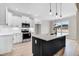 Spacious kitchen featuring a center island with seating, stainless steel appliances, and stylish white cabinets at 186 Gumtop Dr, Zebulon, NC 27597