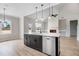 Large kitchen with island, modern appliances, contrasting cabinets, and open to the living room at 186 Gumtop Dr, Zebulon, NC 27597