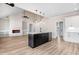 Open-concept kitchen and living area with modern design, stainless appliances, and ample natural light at 186 Gumtop Dr, Zebulon, NC 27597