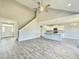 Open-concept living room with a modern kitchen and a staircase leading to the upper level at 186 Gumtop Dr, Zebulon, NC 27597