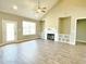 Bright living room featuring a fireplace, built-in shelves, a ceiling fan, and backyard access at 186 Gumtop Dr, Zebulon, NC 27597