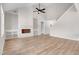 Bright living room with hardwood floors, fireplace, built-in bookshelves and a modern ceiling fan at 186 Gumtop Dr, Zebulon, NC 27597