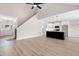Open-concept living and kitchen area with hardwood floors, stainless steel appliances, and plenty of natural light at 186 Gumtop Dr, Zebulon, NC 27597