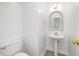Cozy half bath with pedestal sink, decorative mirror, and modern fixtures at 201 Langston Mill Ct, Cary, NC 27518