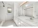 Well-lit bathroom with double sinks, a tub with shower, and ample storage space at 201 Langston Mill Ct, Cary, NC 27518