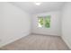 Cozy bedroom with neutral carpet, natural light, and ample closet space at 201 Langston Mill Ct, Cary, NC 27518