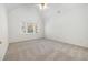 Well-lit bedroom featuring vaulted ceilings and a large window with a view at 201 Langston Mill Ct, Cary, NC 27518