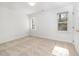 Bright bedroom with neutral carpet, white walls, and natural light from two windows at 201 Langston Mill Ct, Cary, NC 27518