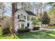 Stately two-story home with brick chimney and mature landscaping in a peaceful setting at 201 Langston Mill Ct, Cary, NC 27518