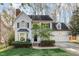 Charming two-story home featuring a well-manicured lawn, attached two car garage, and mature trees at 201 Langston Mill Ct, Cary, NC 27518