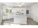 Bright white kitchen with an island, white appliances, tile flooring, and ample storage space at 201 Langston Mill Ct, Cary, NC 27518