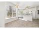 Eat-in kitchen with tile flooring, bright white cabinets, and a large window overlooking the backyard at 201 Langston Mill Ct, Cary, NC 27518