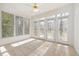 Bright sunroom featuring neutral carpet, multiple windows, and glass doors leading to outdoor area at 201 Langston Mill Ct, Cary, NC 27518