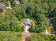 Aerial view of a beautiful home nestled among lush trees, offering privacy and tranquility at 205 Sacred Fire Rd, Louisburg, NC 27549