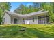 Spacious backyard with a screened-in porch, sliding glass doors, and lush green lawn for outdoor enjoyment at 205 Sacred Fire Rd, Louisburg, NC 27549