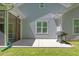 A cozy back patio with a grill, window, and screened-in porch offers a tranquil outdoor living space at 205 Sacred Fire Rd, Louisburg, NC 27549