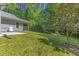 Beautiful backyard with lush green lawn and mature trees offering a private and serene outdoor space at 205 Sacred Fire Rd, Louisburg, NC 27549