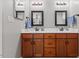 Bathroom featuring dual sinks, wooden cabinetry, and ample counter space at 205 Sacred Fire Rd, Louisburg, NC 27549