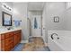 Bathroom featuring a walk-in shower, separate soaking tub, and dual sinks at 205 Sacred Fire Rd, Louisburg, NC 27549