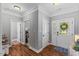 Welcoming entryway featuring hardwood floors, crown molding, and a decorative front door with sidelights at 205 Sacred Fire Rd, Louisburg, NC 27549