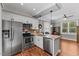 Modern kitchen with stainless steel appliances, granite countertops, and white cabinets at 205 Sacred Fire Rd, Louisburg, NC 27549