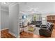 Cozy living room featuring comfortable leather seating, neutral decor, and ample natural light at 205 Sacred Fire Rd, Louisburg, NC 27549