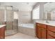 Relaxing bathroom featuring a soaking tub and separate shower at 2106 Cloud Cover Ln, Raleigh, NC 27614
