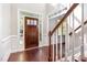Elegant foyer with hardwood floors, staircase, and a stylish front door with glass panels at 2106 Cloud Cover Ln, Raleigh, NC 27614