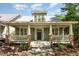 Charming home with a inviting front porch featuring brick accents and a well-manicured garden at 2106 Cloud Cover Ln, Raleigh, NC 27614