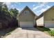View of home's attached garage, long concrete driveway, and light green horizontal siding at 2106 Cloud Cover Ln, Raleigh, NC 27614