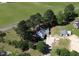 A high angle aerial view shows home with mature trees surrounded by green fields at 2122 Pleasant Hill Rd, Rocky Mount, NC 27801