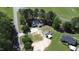 A high angle aerial view shows home with mature trees surrounded by green fields at 2122 Pleasant Hill Rd, Rocky Mount, NC 27801