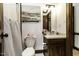 Well-lit bathroom with a clean vanity, mirror, and striped shower curtain at 2122 Pleasant Hill Rd, Rocky Mount, NC 27801