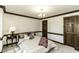 Well-lit bedroom features a comfortable bed, side table, and two doors at 2122 Pleasant Hill Rd, Rocky Mount, NC 27801